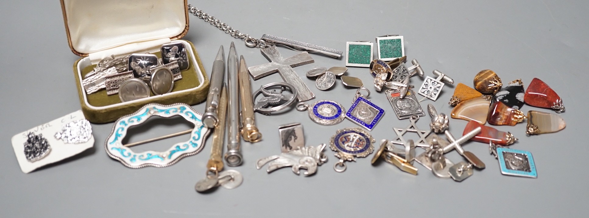 A white gold two colour enamel and diamond chip set Royal Artillery sweethearts brooch